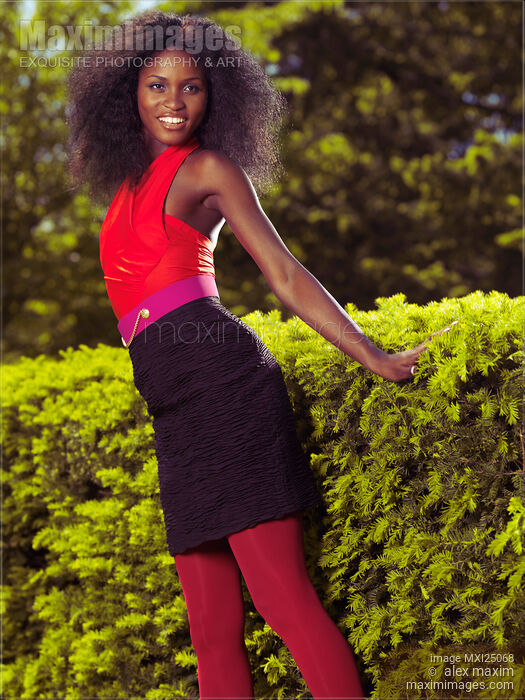 Smiling Young African American Woman in a park Stock photo of Smiling Young African American Woman in a park Buy commercial use license at MaximImages