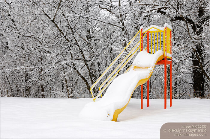 Stock photo of Snow covered slide on playground in winter Buy commercial use license at MaximImages