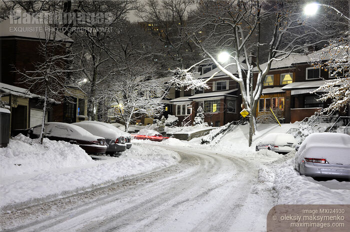 Stock photo of Snow covered street at night Buy commercial use license at MaximImages