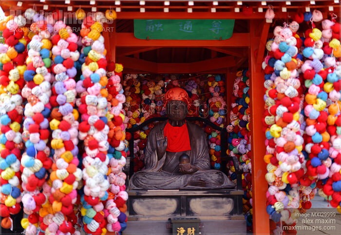 Stock photo of Statue of Koshin-san guardian at Yasaka Koshin-do small temple in Kyoto with colorful cloth monkey balls Kukurizaru Buy commercial use license at MaximImages