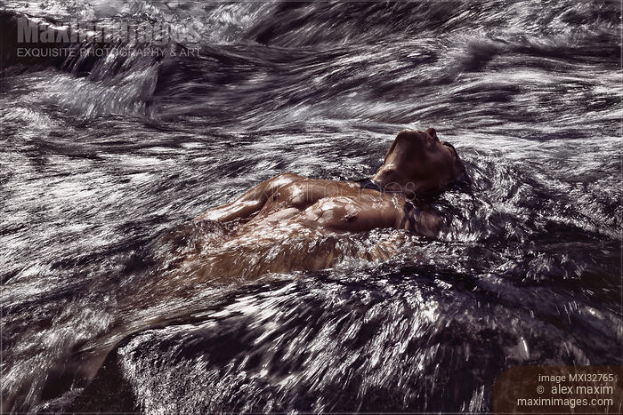 Stock photo of Strong muscular naked male body wet bare torso carried by turbulent river water or stormy sea waves Buy commercial use license at MaximImages