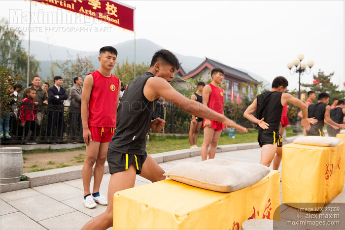 Stock photo of Students of Tagou Shaolin martial arts school conditioning their hands Buy commercial use license at MaximImages