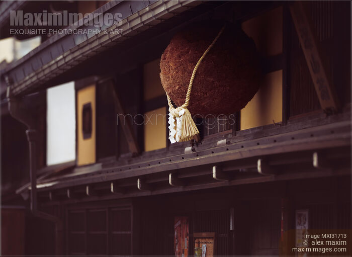 Stock photo of Sugidama aged cedar orb with Shimenawa rope hanging above entrance of a Sake Brewery in Takayama Japan Buy commercial use license at MaximImages