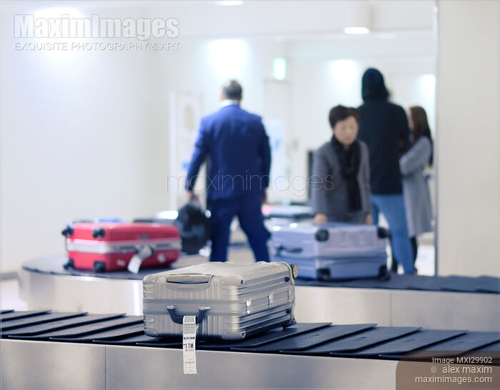 Stock photo of Suitcases on airport baggage claim conveyor Buy commercial use license at MaximImages