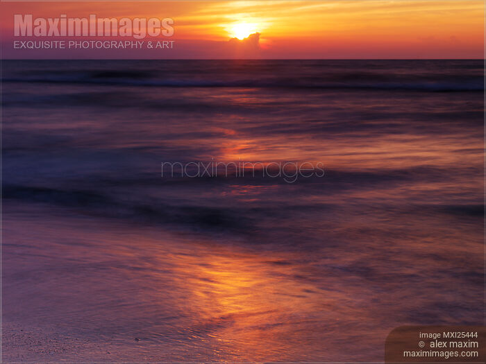 Stock photo of Sun setting down over Huron lake Buy commercial use license at MaximImages