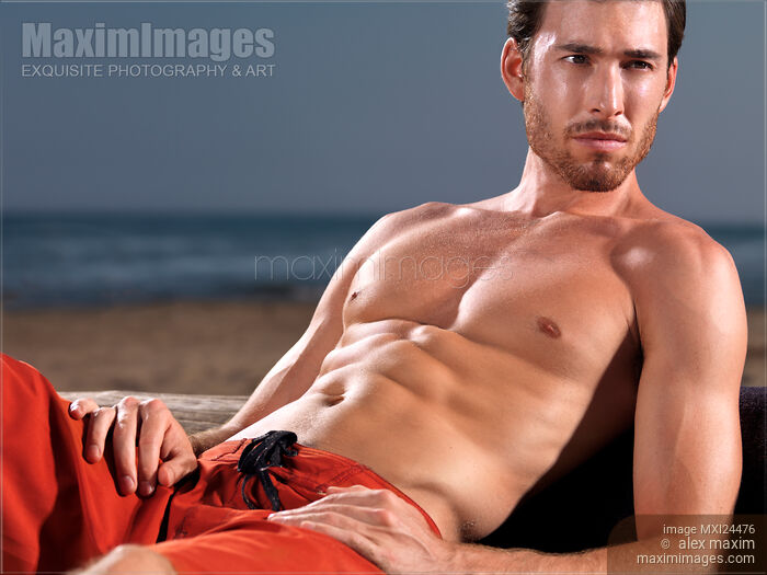 Stock photo of Suntanned young man at the beach Buy commercial use license at MaximImages