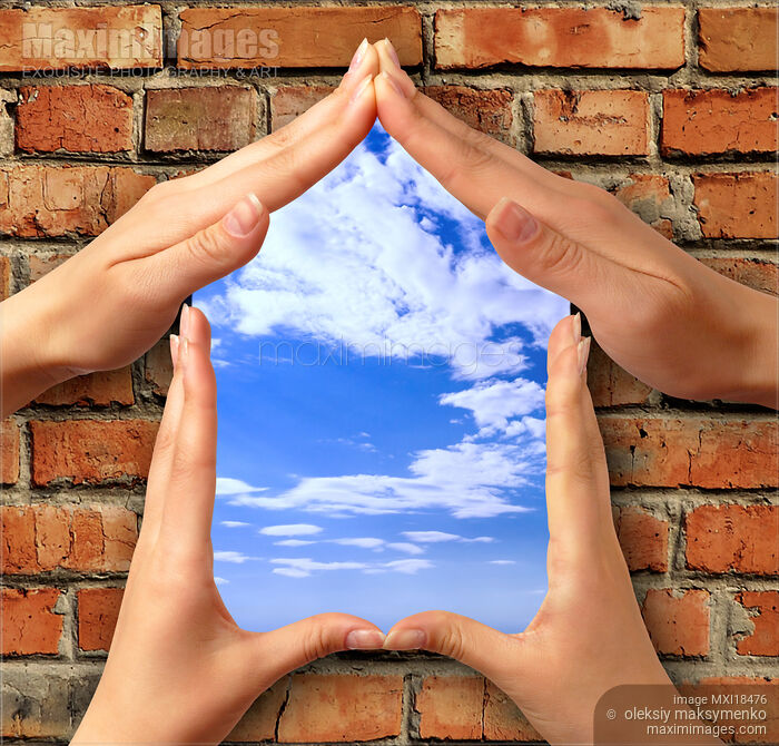 Stock photo of Symbol home over brick wall Buy commercial use license at MaximImages