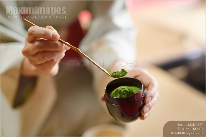 Tea ceremony master holding a bamboo spoon Chashaku of matcha green tea powder Stock photo of Tea ceremony master holding a bamboo spoon Chashaku of matcha green tea powder Buy commercial use license at MaximImages