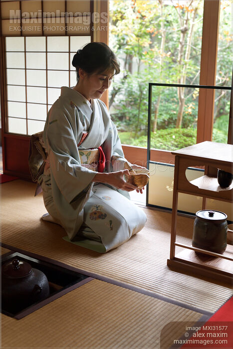 Stock photo of Tea ceremony master serving matcha tea in a bowl in a traditional Japanese tea house Buy commercial use license at MaximImages
