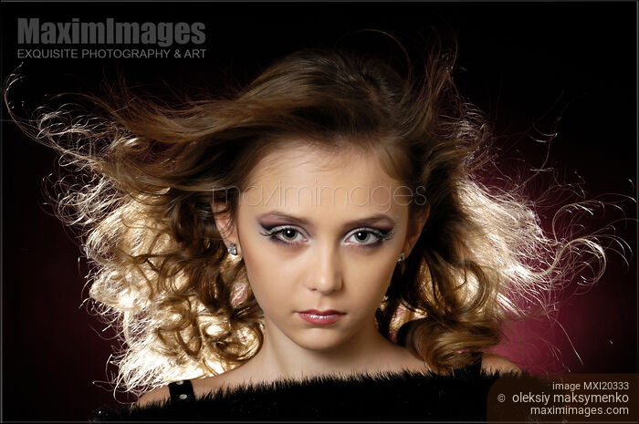 Stock photo of Teenage girl face with artistic makeup and flying hair Buy commercial use license at MaximImages