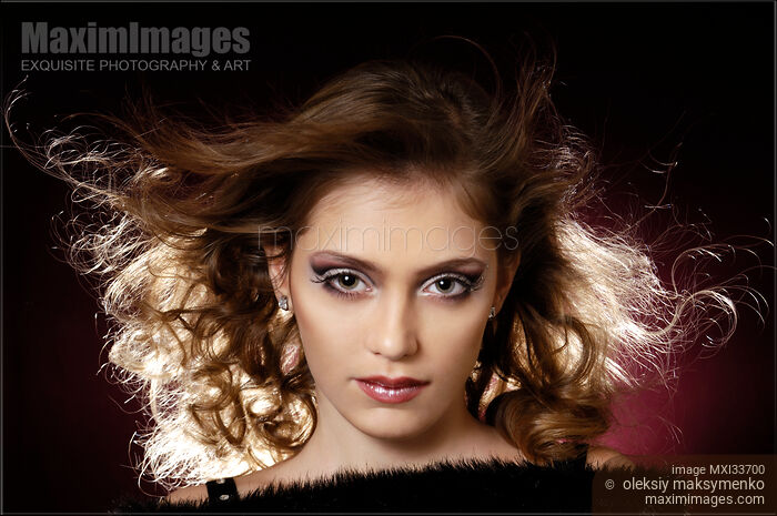 Stock photo of Teenage girl face with artistic makeup and flying hair Buy commercial use license at MaximImages