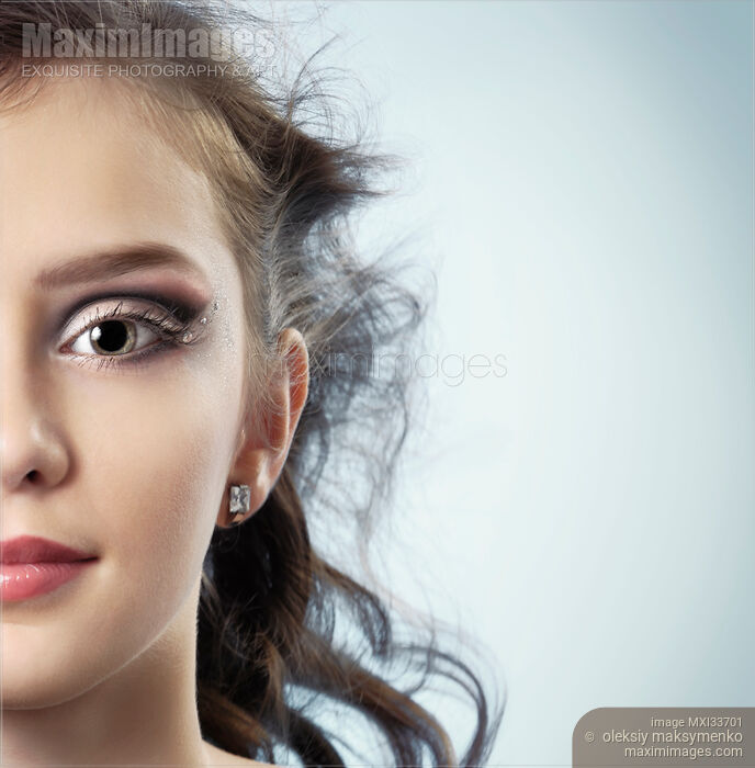 Stock photo of Teenage girl half face with artistic eye-shadow makeup Buy commercial use license at MaximImages