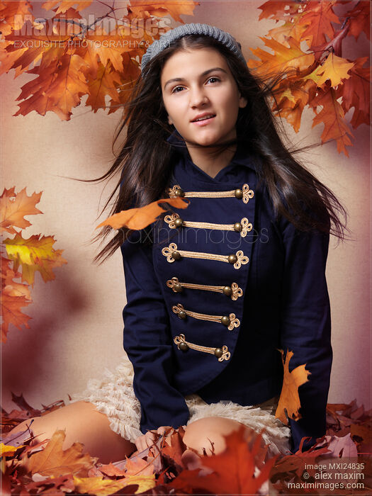 Teenage girl surrounded with autumn leaves Stock photo of Teenage girl surrounded with autumn leaves Buy commercial use license at MaximImages