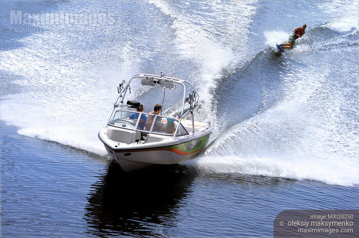 Stock photo of Teenage Girl Wakeboarder Behind a Motorboat Buy commercial use license at MaximImages