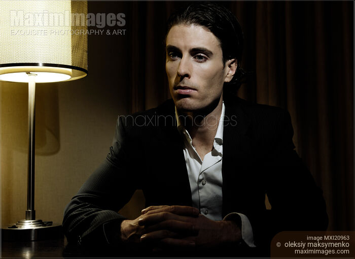 Stock photo of Thoughtful Young Man at the Desk Buy commercial use license at MaximImages