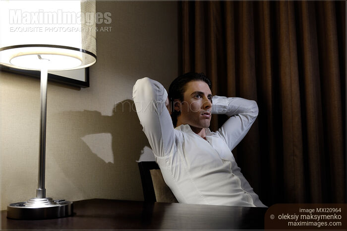 Stock photo of Thoughtful Young Man at the Desk Buy commercial use license at MaximImages