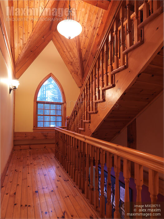 Stock photo of Timber frame cottage style Canadian house wooden staircase and gothic arched window Buy commercial use license at MaximImages