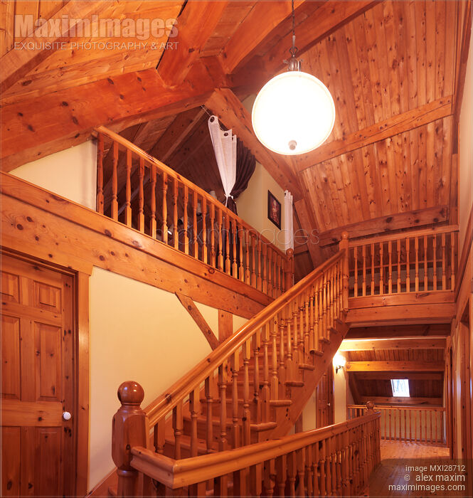 Timber frame cottage style Canadian house wooden staircase leading to the loft Stock photo of Timber frame cottage style Canadian house wooden staircase leading to the loft Buy commercial use license at MaximImages