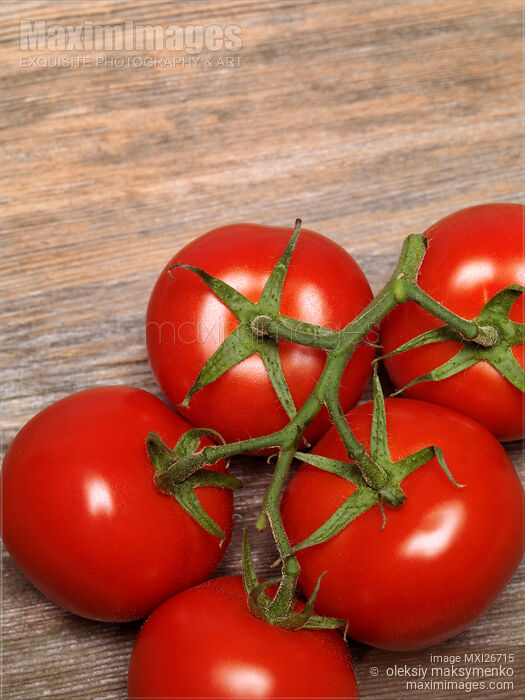 Stock photo of Tomatoes on wooden background Buy commercial use license at MaximImages