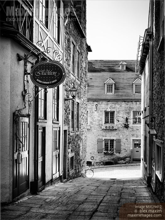 Stock photo of Tradition boutique store sign in small historic street of Old Quebec City Black and white Buy commercial use license at MaximImages