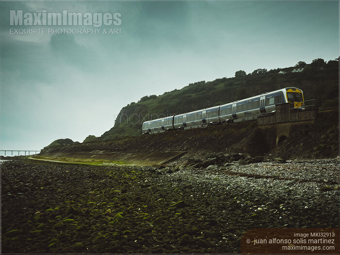 Stock photo of Train going to Whitehead County Antrim Northern Ireland moody landscape scenery Buy commercial use license at MaximImages