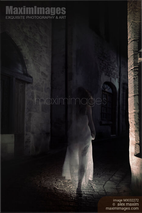 Transparent ghost of a woman in white dress walking along an old street of a historic town Stock photo of Transparent ghost of a woman in white dress walking along an old street of a historic town Buy commercial use license at MaximImages