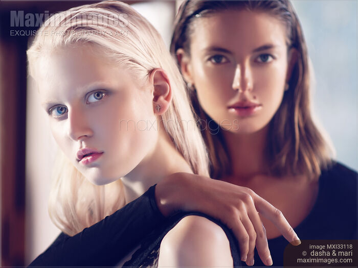 Stock photo of Two beautiful women blond and brunette female couple with sleek stylish fashionable look Buy commercial use license at MaximImages