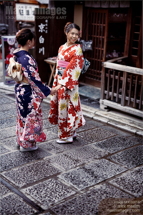 Two girls in bright Yukatas posing for a photo on a Kyoto street Stock photo of Two girls in bright Yukatas posing for a photo on a Kyoto street Buy commercial use license at MaximImages