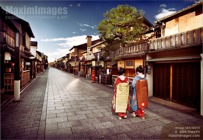 Stock photo of Two Maiko Geisha apprentices in kimono on Hanamikoji street in Gion district Kyoto Japan Buy commercial use license at MaximImages