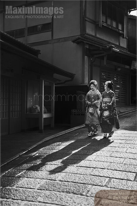 Two Maiko in kimono walking down an old street in Kyoto Japan Black and white Stock photo of Two Maiko in kimono walking down an old street in Kyoto Japan Black and white Buy commercial use license at MaximImages