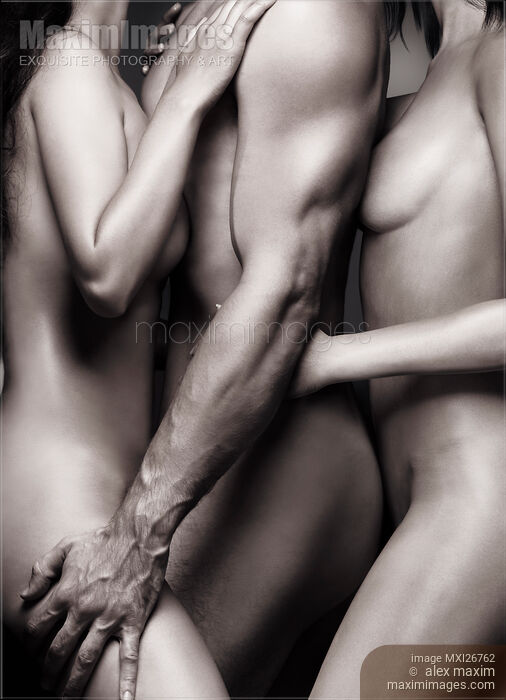 Two nude women with one man. Sexy love threesome art nude closeup. Stock Image MXI26762 © Alex Maxim / MaximImages