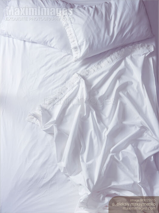 Stock photo of Unmade bed view from above Buy commercial use license at MaximImages