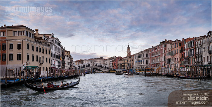 Venice Grand Canal and Rialto Bridge with boats and gondolas with beautiful historic Venetian architecture panorama Stock photo of Venice Grand Canal and Rialto Bridge with boats and gondolas with beautiful historic Venetian architecture panorama Buy commercial use license at MaximImages