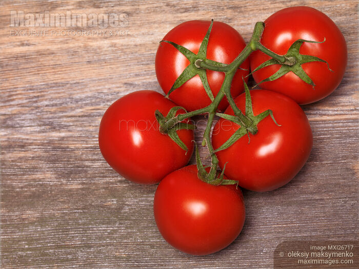 Stock photo of Vine tomatoes on wood Buy commercial use license at MaximImages