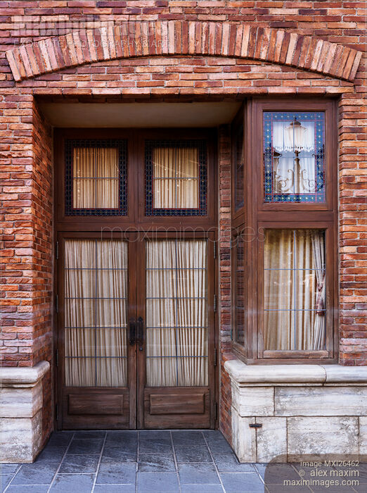 Stock photo of Vintage door of brick house Buy commercial use license at MaximImages