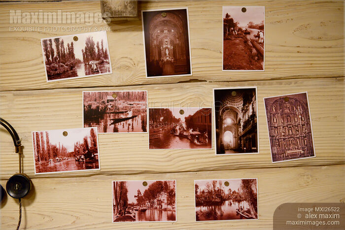 Stock photo of Vintage pictures pinned to wooden wall Buy commercial use license at MaximImages