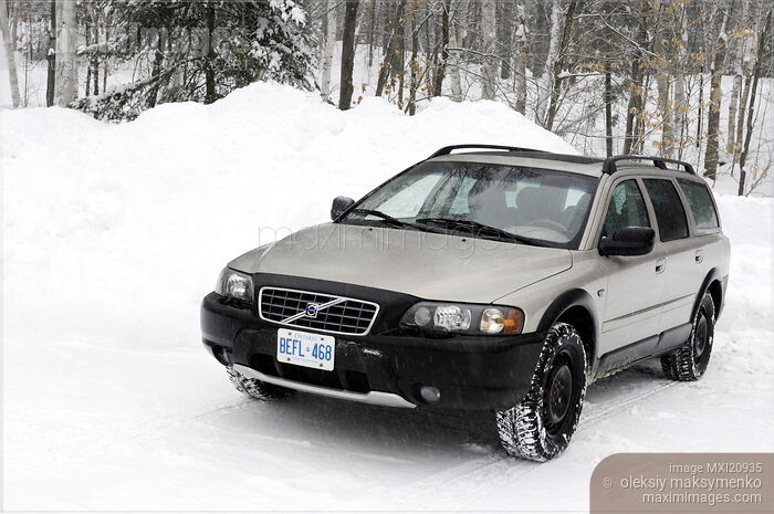 Stock photo of Volvo XC70 station wagon car on a snow covered road in Canada Buy commercial use license at MaximImages