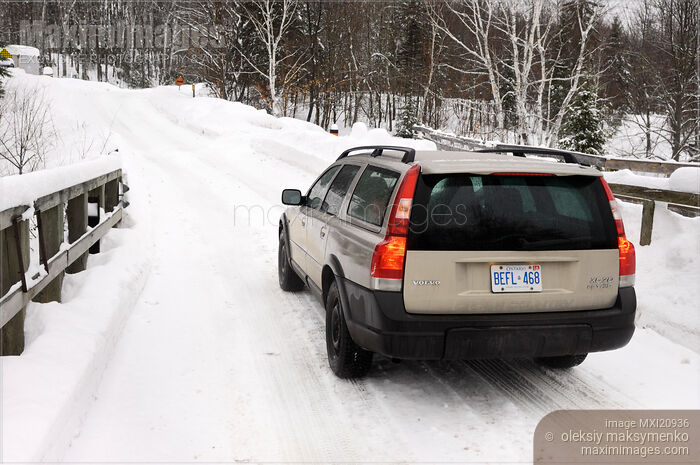 Stock photo of Volvo XC70 station wagon Winter travel on a snow covered road Buy commercial use license at MaximImages
