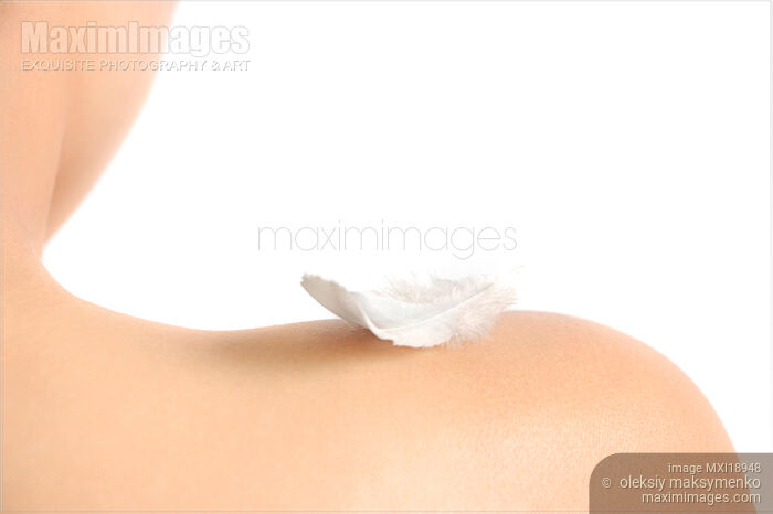 Stock photo of White feather on bare woman shoulder Buy commercial use license at MaximImages