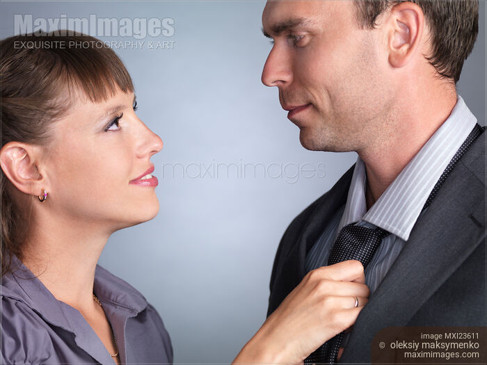 Woman Adjusting Man's Tie Stock photo of Woman Adjusting Man's Tie Buy commercial use license at MaximImages