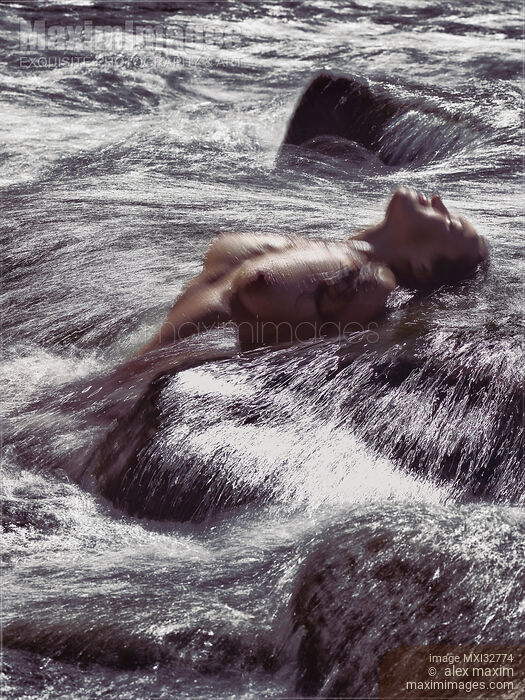 Woman bathing naked in water of a wild river or stormy sea shore with her nude body arched and breasts above water Stock photo of Woman bathing naked in water of a wild river or stormy sea shore with her nude body arched and breasts above water Buy commercial use license at MaximImages
