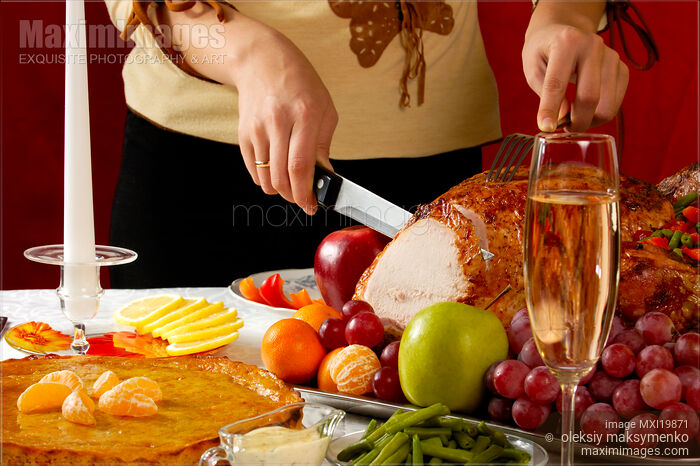Stock photo of Woman Carving a Turkey Buy commercial use license at MaximImages