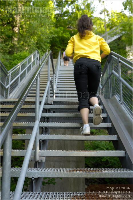 Woman Climbing up the Stairs Stock photo of Woman Climbing up the Stairs Buy commercial use license at MaximImages