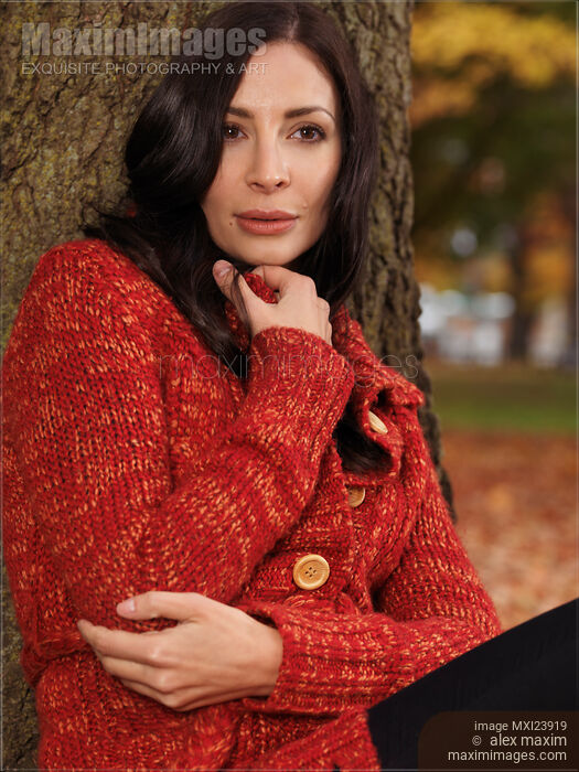 Stock photo of Woman Cuddling in a Sweater in Fall Buy commercial use license at MaximImages