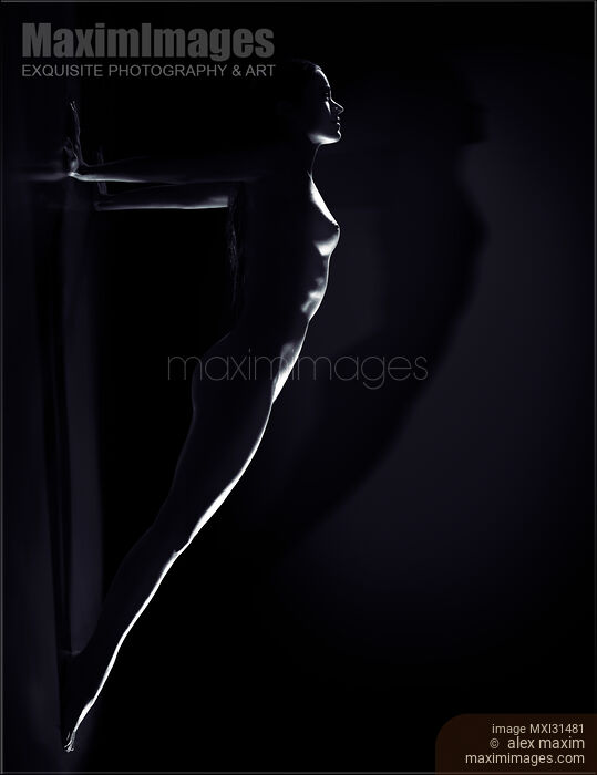 Stock photo of Woman defying gravity doing a plank against the wall naked body outline Inspirational art nude Buy commercial use license at MaximImages