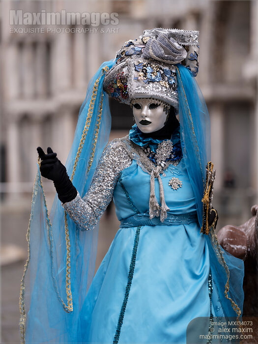Stock photo of Woman dressed in blue and silver carnival costume and a mask during the Carnival of Venice Italy Buy commercial use license at MaximImages