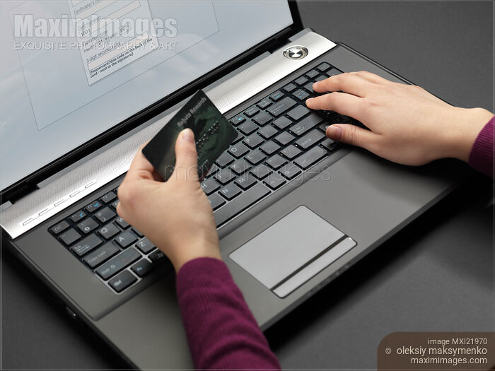Stock photo of Woman Entering Her Credit Card Information Buy commercial use license at MaximImages