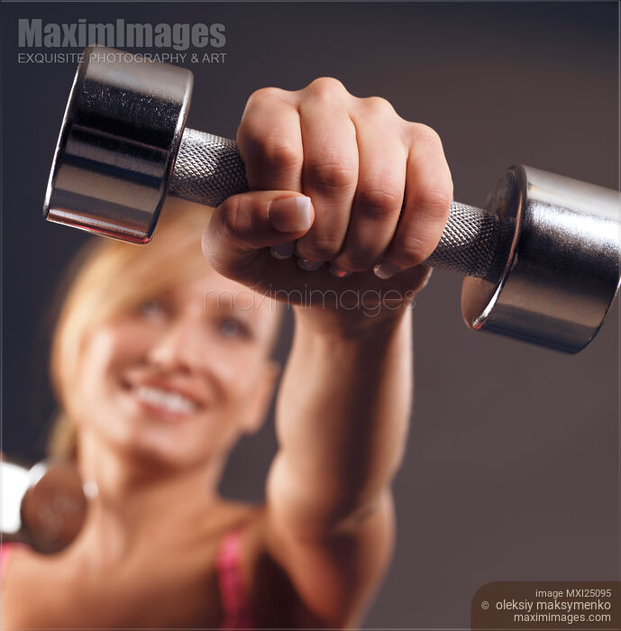 Woman exercising with weights Stock photo of Woman exercising with weights Buy commercial use license at MaximImages