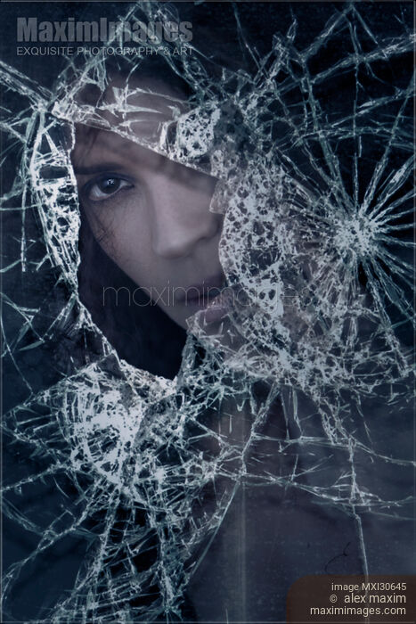 Woman face behind broken window glass with expressive look Stock photo of Woman face behind broken window glass with expressive look Buy commercial use license at MaximImages