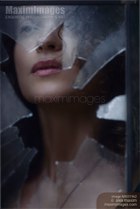 Woman face visible through a hole in a window looking through broken glass Stock photo of Woman face visible through a hole in a window looking through broken glass Buy commercial use license at MaximImages